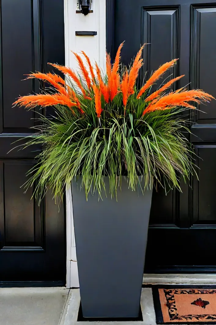 Tall Grasses and Bittersweet Branches Tall gray fiberglass planter with ornamental grass for striking tall fall outdoor planter ideas.